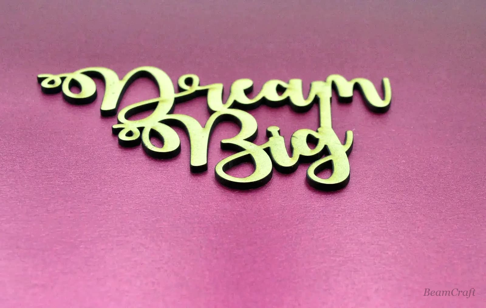 Macro of mirror gold acrylic script lettering