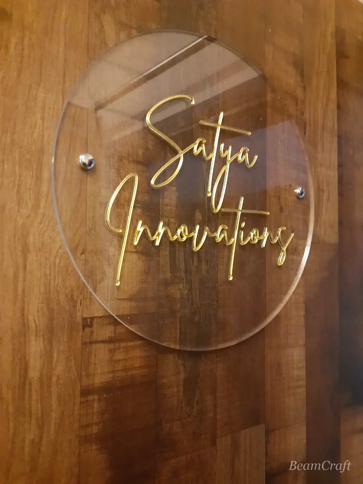 Macro of clear acrylic panel with raised gold lettering