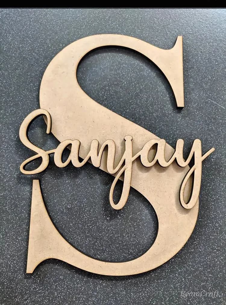 Macro of natural MDF cut into layered script letters